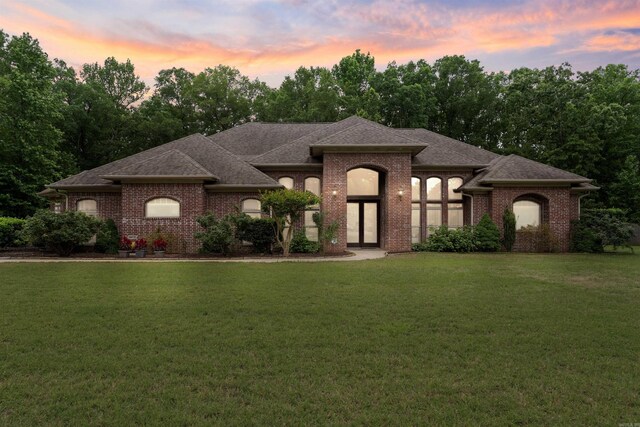 529 Enchanted Valley Ln, North Little Rock, AR 72118 - french provincial home with a front yard, brick siding, and a shingled roof