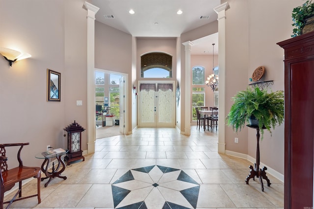 529 Enchanted Valley Ln, North Little Rock, AR 72118 - entrance foyer with decorative columns, a towering ceiling, light tile patterned floors, recessed lighting, and a chandelier