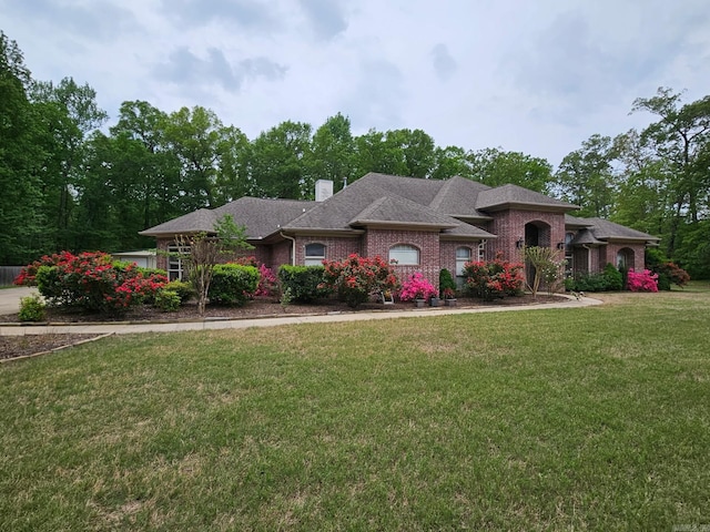 529 Enchanted Valley Ln, North Little Rock, AR 72118 - view of front of home featuring a front yard, a chimney, and brick siding