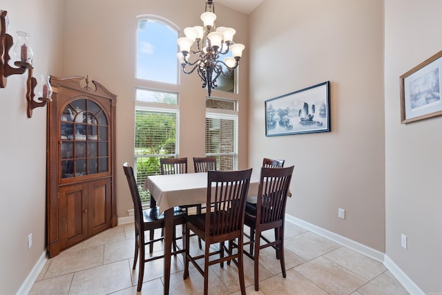 529 Enchanted Valley Ln, North Little Rock, AR 72118 - dining space with a chandelier, light tile patterned flooring, a high ceiling, and baseboards