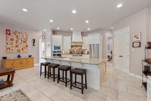 529 Enchanted Valley Ln, North Little Rock, AR 72118 - kitchen with stainless steel appliances, wall chimney exhaust hood, decorative backsplash, light tile patterned floors, and recessed lighting