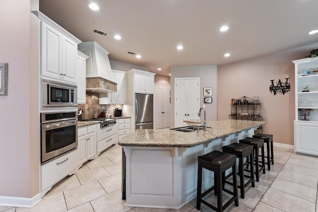 529 Enchanted Valley Ln, North Little Rock, AR 72118 - kitchen featuring a sink, appliances with stainless steel finishes, backsplash, a breakfast bar area, and recessed lighting