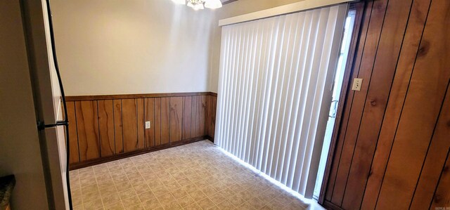 empty room with a wainscoted wall and light floors