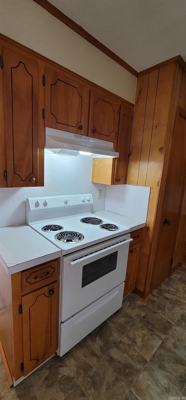 kitchen featuring white range with electric stovetop, under cabinet range hood, brown cabinetry, light countertops, and crown molding