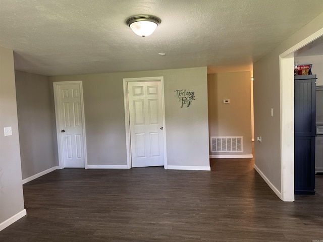 251 Grouse Trl, Pocahontas, AR 72455 - unfurnished room featuring dark wood finished floors, baseboards, and a textured ceiling