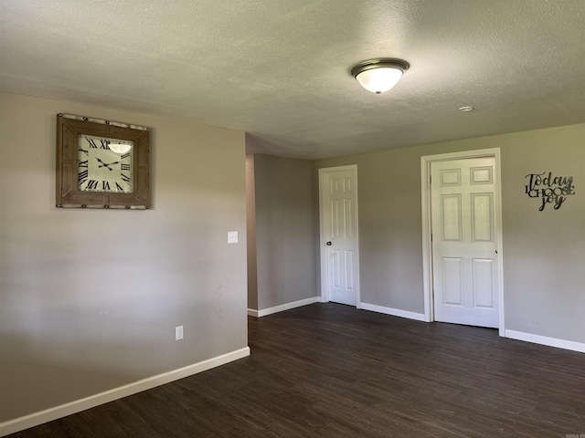 251 Grouse Trl, Pocahontas, AR 72455 - spare room with a textured ceiling, dark wood-style flooring, and baseboards