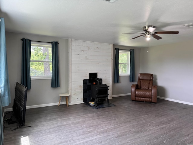 251 Grouse Trl, Pocahontas, AR 72455 - living area with a wood stove, a ceiling fan, wood finished floors, and baseboards