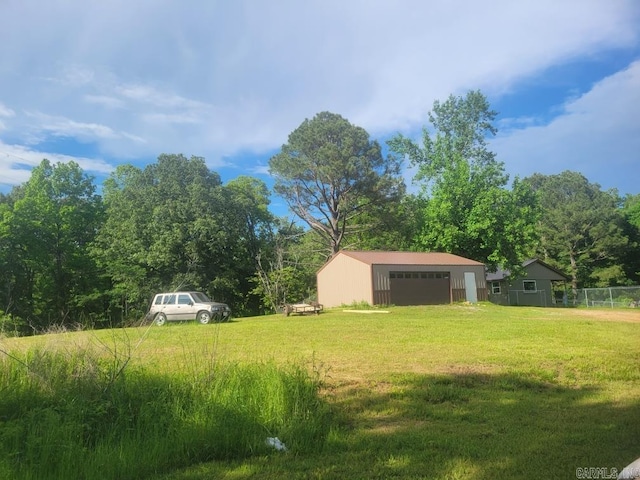 251 Grouse Trl, Pocahontas, AR 72455 - view of yard with a detached garage and an outbuilding