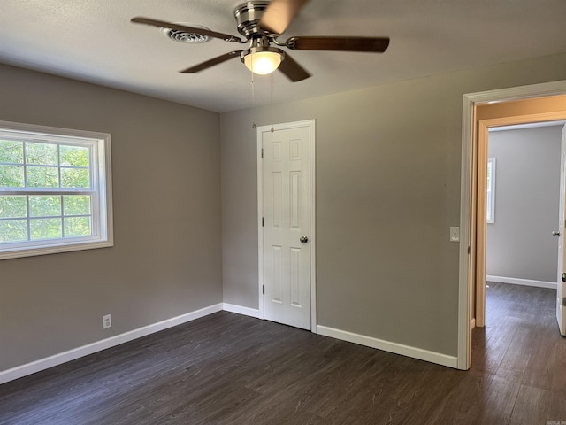 251 Grouse Trl, Pocahontas, AR 72455 - empty room with dark wood-type flooring, a ceiling fan, and baseboards