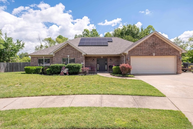 3407 Hemlock Cv, Benton, AR 72015 - ranch-style home with a garage, brick siding, driveway, a shingled roof, and solar panels