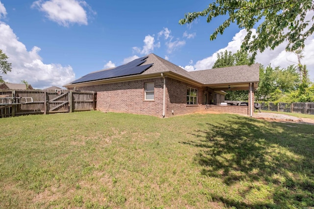 3407 Hemlock Cv, Benton, AR 72015 - view of side of home with brick siding, solar panels, a gate, and roof with shingles