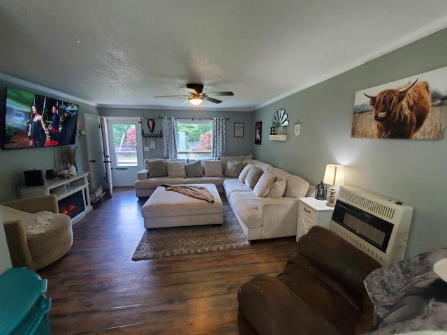690 Redwood Dr, Piggott, AR 72454 - living room featuring heating unit, a fireplace, crown molding, wood finished floors, and a ceiling fan