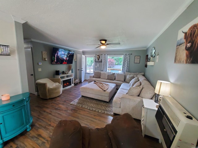690 Redwood Dr, Piggott, AR 72454 - living area featuring ornamental molding, wood finished floors, ceiling fan, and heating unit