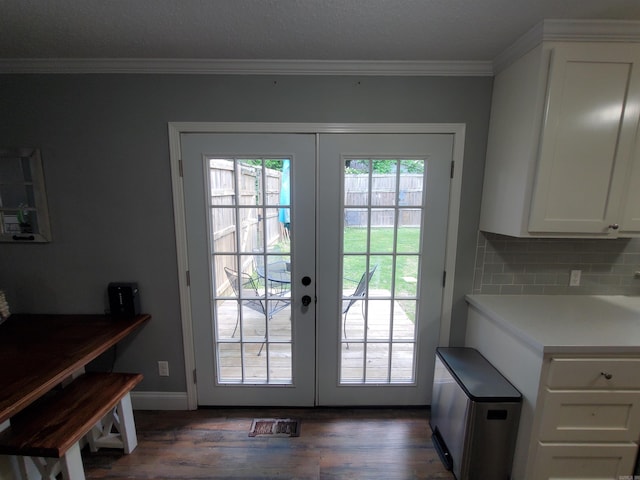 690 Redwood Dr, Piggott, AR 72454 - doorway to outside with french doors, dark wood finished floors, ornamental molding, and baseboards