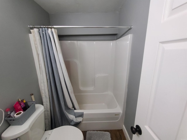 690 Redwood Dr, Piggott, AR 72454 - bathroom featuring wood finished floors, a shower with curtain, and toilet