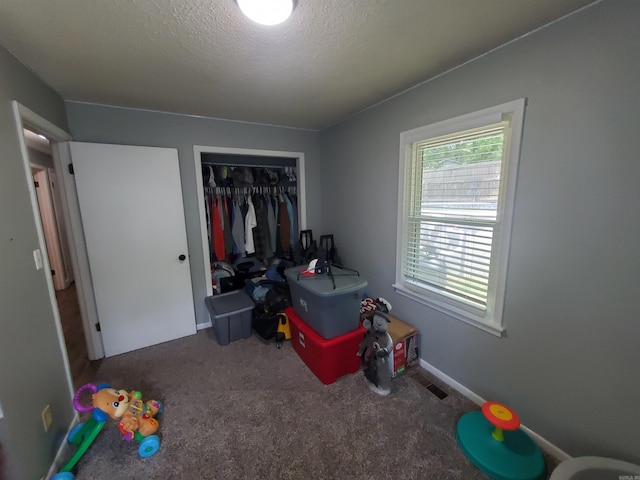 690 Redwood Dr, Piggott, AR 72454 - game room featuring carpet floors and a textured ceiling