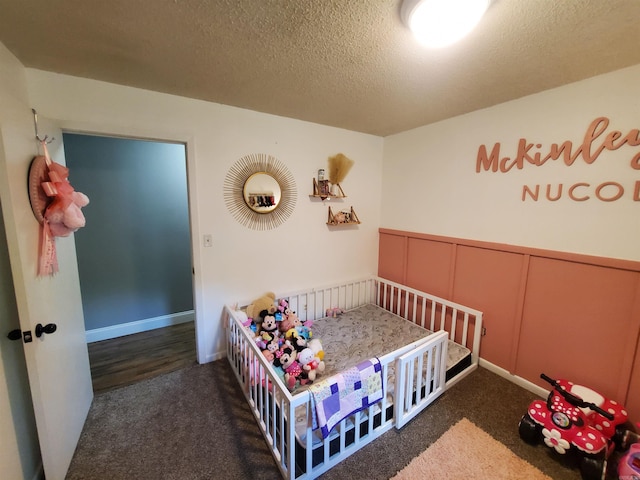 690 Redwood Dr, Piggott, AR 72454 - bedroom with carpet flooring, a wainscoted wall, a textured ceiling, and a decorative wall