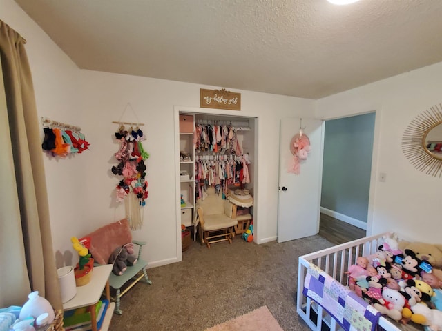 690 Redwood Dr, Piggott, AR 72454 - carpeted bedroom featuring a closet, a textured ceiling, and baseboards