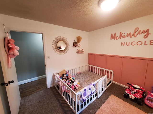 690 Redwood Dr, Piggott, AR 72454 - bedroom with a wainscoted wall, carpet flooring, a decorative wall, and a textured ceiling