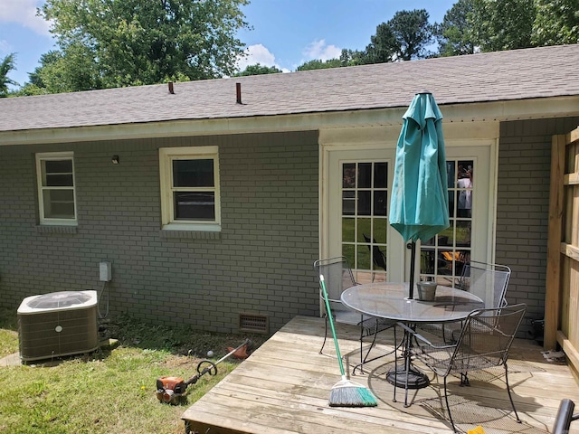 690 Redwood Dr, Piggott, AR 72454 - wooden deck featuring central AC unit and outdoor dining space
