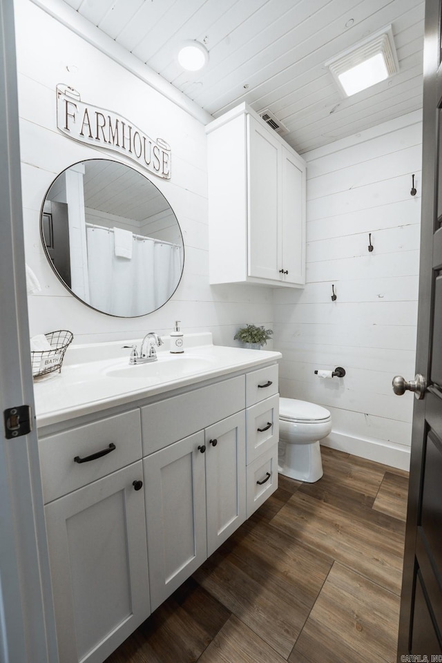 948 Sunny Slope Rd, Edgemont, AR 72044 - full bathroom with vanity, toilet, wood finished floors, wooden ceiling, and wooden walls