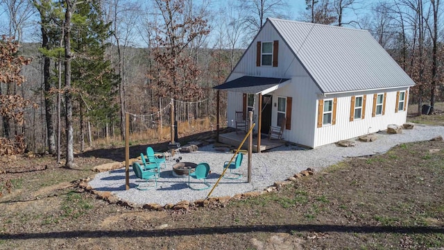948 Sunny Slope Rd, Edgemont, AR 72044 - view of side of home with an outdoor fire pit, metal roof, and a patio
