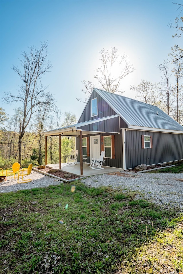 948 Sunny Slope Rd, Edgemont, AR 72044 - back of house with metal roof, board and batten siding, and a patio area