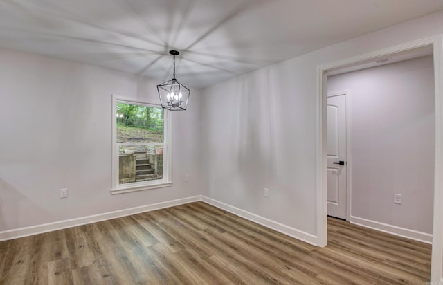 1114 Edgehill Dr, Benton, AR 72015 - empty room featuring wood finished floors, a chandelier, and baseboards