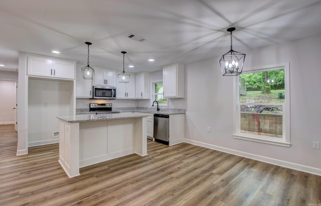 1114 Edgehill Dr, Benton, AR 72015 - kitchen featuring appliances with stainless steel finishes, light wood-style floors, white cabinets, and recessed lighting