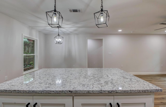 1114 Edgehill Dr, Benton, AR 72015 - kitchen featuring light wood-style flooring, light stone countertops, white cabinetry, baseboards, and recessed lighting