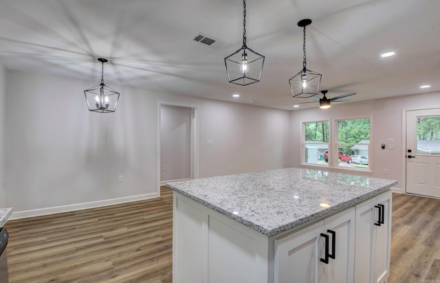 1114 Edgehill Dr, Benton, AR 72015 - kitchen with light wood-type flooring, white cabinetry, hanging light fixtures, ceiling fan, and baseboards