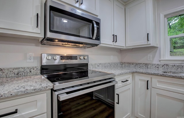 1114 Edgehill Dr, Benton, AR 72015 - kitchen featuring appliances with stainless steel finishes, white cabinets, wood finished floors, and light stone counters