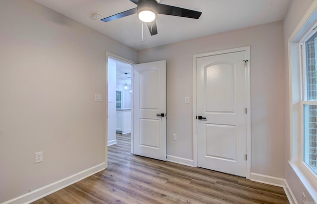 1114 Edgehill Dr, Benton, AR 72015 - unfurnished bedroom with wood finished floors, baseboards, and a ceiling fan