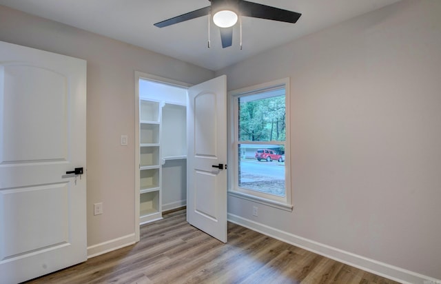 1114 Edgehill Dr, Benton, AR 72015 - unfurnished bedroom with light wood-type flooring, baseboards, and ceiling fan