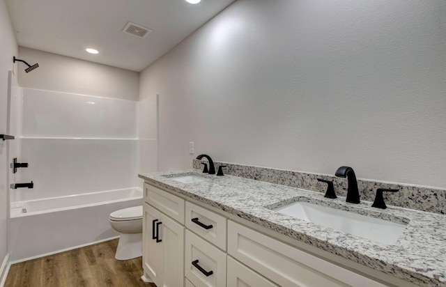 1114 Edgehill Dr, Benton, AR 72015 - bathroom featuring toilet, wood finished floors, double vanity, bathing tub / shower combination, and recessed lighting
