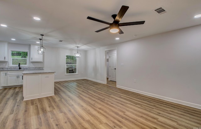 1114 Edgehill Dr, Benton, AR 72015 - kitchen with white cabinets, recessed lighting, a sink, light wood-style flooring, and baseboards