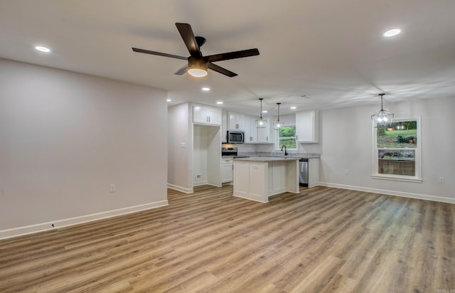 1114 Edgehill Dr, Benton, AR 72015 - kitchen featuring stainless steel appliances, open floor plan, recessed lighting, a sink, and white cabinetry