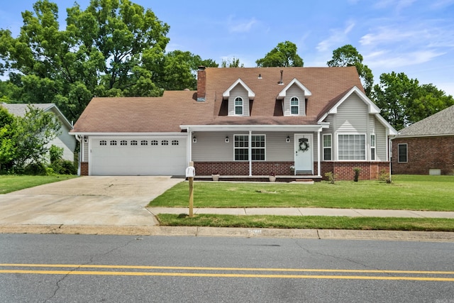 view of front facade featuring brick siding, a garage, driveway, a front lawn, and a chimney