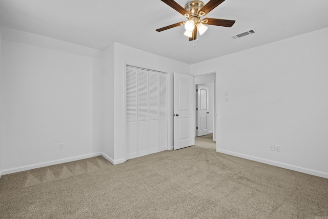unfurnished bedroom featuring carpet, baseboards, and a closet