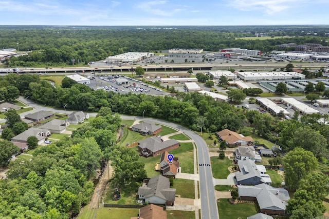aerial overview of property's location with a heavily wooded area