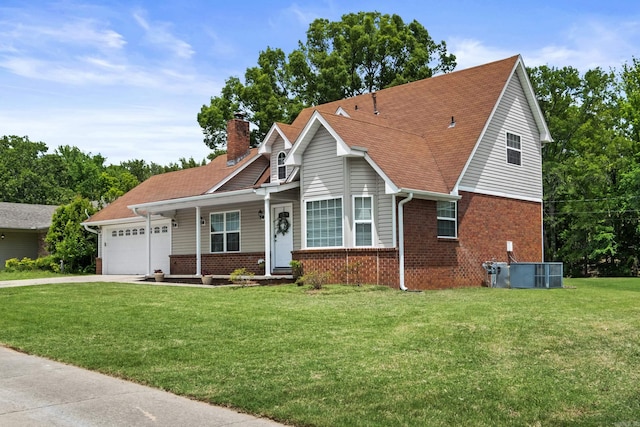 view of front of property featuring brick siding, a chimney, a garage, and a front lawn
