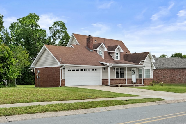 view of front of house featuring brick siding, a garage, covered porch, and a front yard