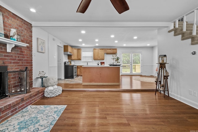living room with light wood-style flooring, ceiling fan, recessed lighting, stairway, and baseboards