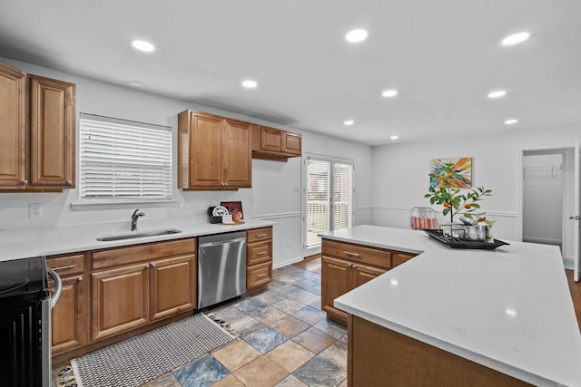 kitchen with stainless steel dishwasher, a sink, recessed lighting, light countertops, and light stone finish flooring