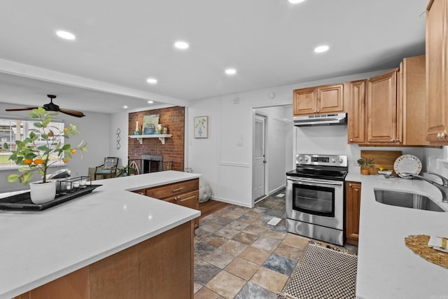 kitchen with stainless steel range with electric cooktop, a sink, light countertops, recessed lighting, and under cabinet range hood