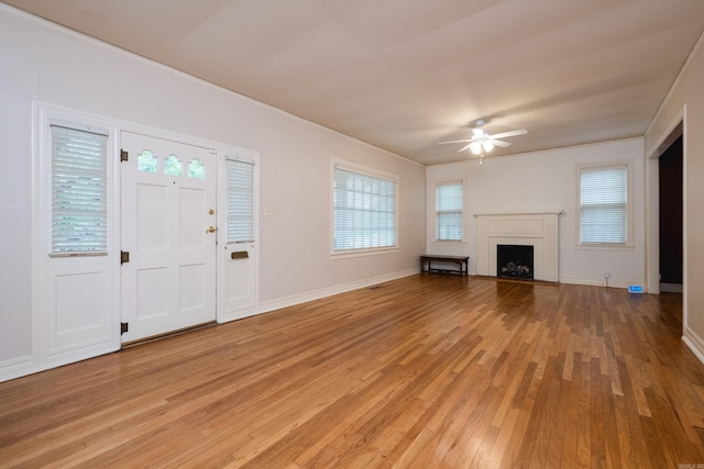 111 Thayer St, Little Rock, AR 72205 - unfurnished living room featuring ceiling fan, light wood-style floors, baseboards, and a brick fireplace
