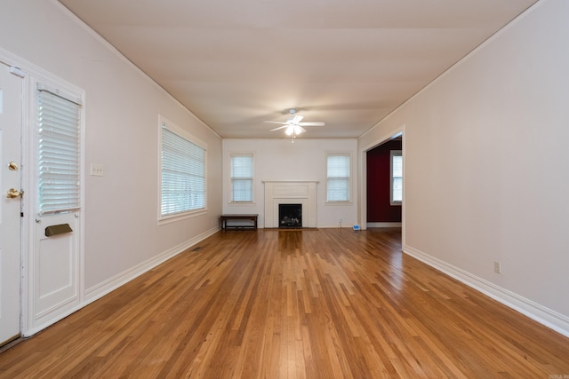 111 Thayer St, Little Rock, AR 72205 - unfurnished living room featuring a ceiling fan, light wood-style flooring, a brick fireplace, baseboards, and ornamental molding
