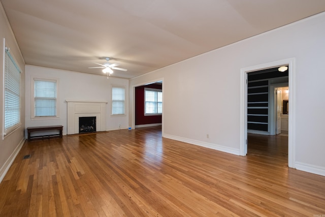 111 Thayer St, Little Rock, AR 72205 - unfurnished living room with ceiling fan, a brick fireplace, light wood finished floors, baseboards, and ornamental molding