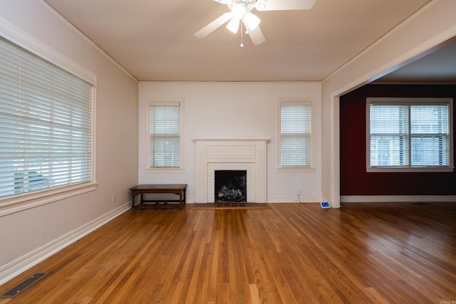 111 Thayer St, Little Rock, AR 72205 - unfurnished living room with a ceiling fan, wood finished floors, a brick fireplace, and baseboards