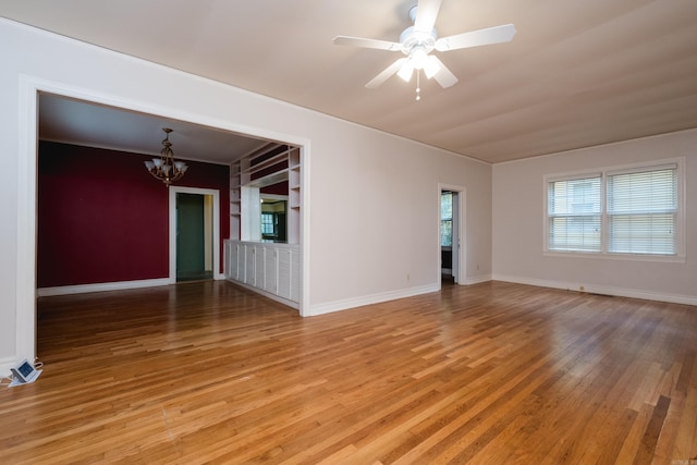111 Thayer St, Little Rock, AR 72205 - empty room featuring a chandelier, light wood-style floors, a ceiling fan, and baseboards